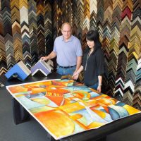 man and woman working at framing table