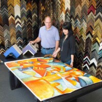 man and woman working at framing table