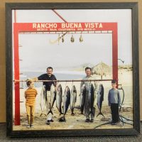 framed photo fo 2 men and 2 boys with caught fish