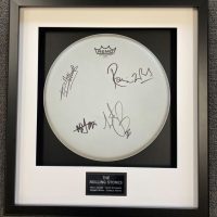 framed drum signed by The Rolling Stones